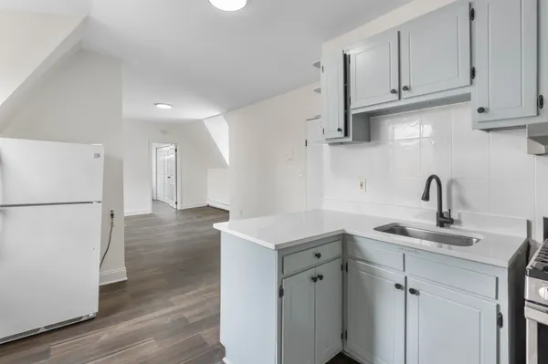 a kitchen with sink cabinets and refrigerator