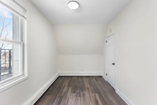 a view of a room with wooden floor and window