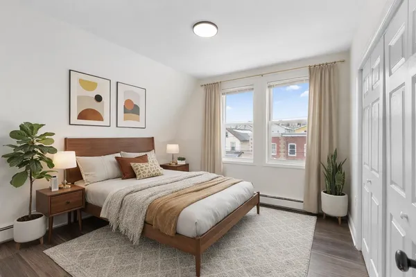 a spacious bedroom with a bed and a window