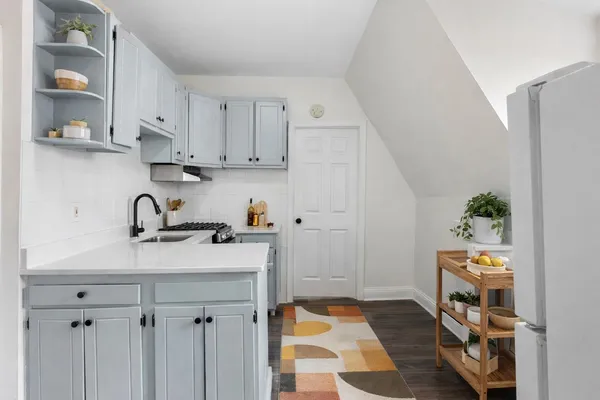 a view of kitchen with sink and cabinets