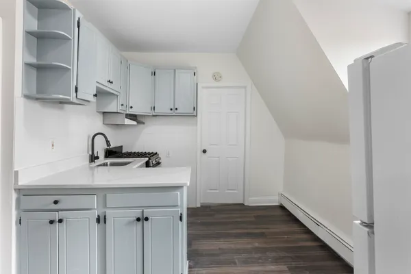 a view of a kitchen with sink and cabinets