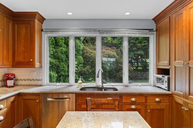 a kitchen with large windows and a sink