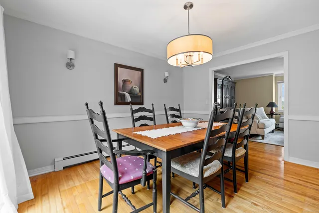 a view of a dining room and hall with wooden floor