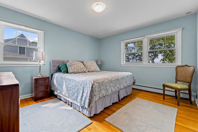 a bedroom with a bed and a lounge chair