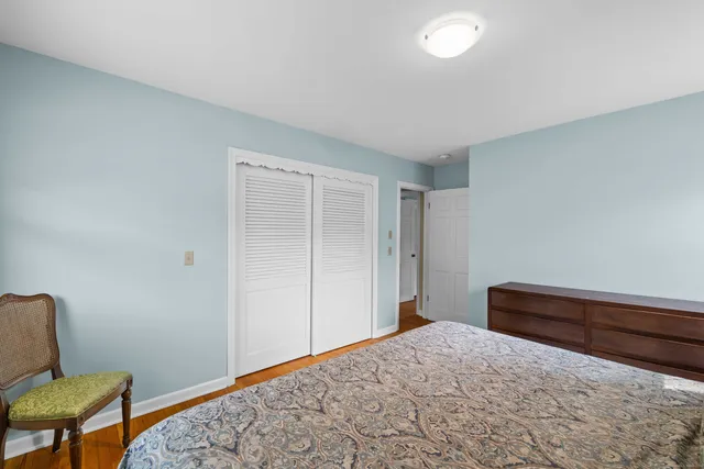 a bedroom with a bed and chair