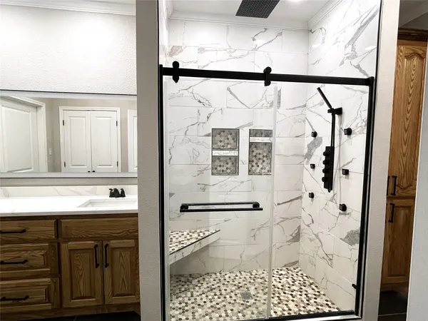a bathroom with a glass shower door