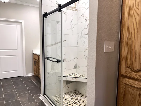 a bathroom with a shower and a sink