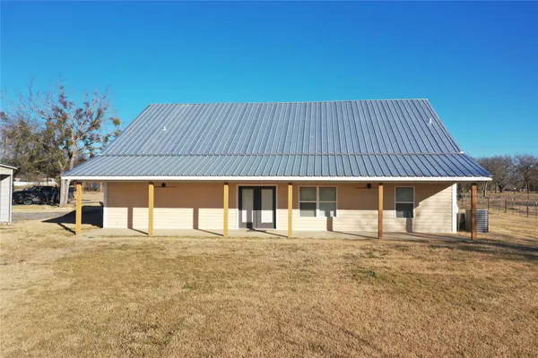 a yard with table and chairs