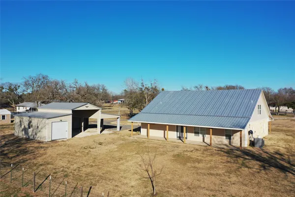 a view of a house with a wooden fence
