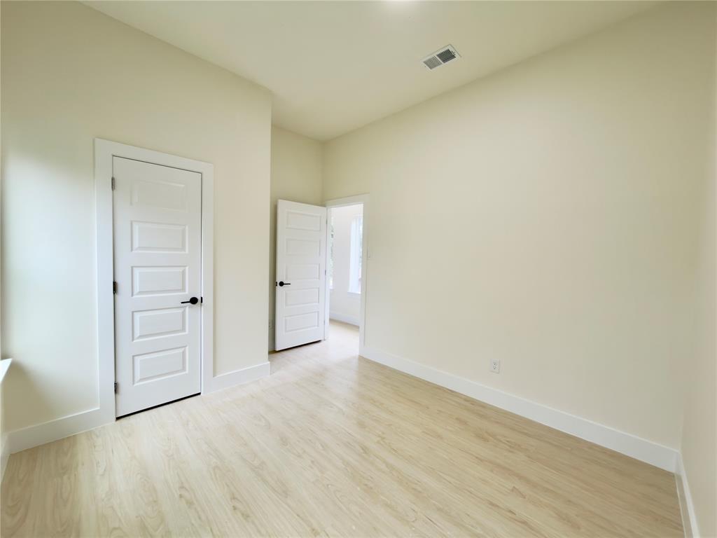 3119 Parvia Avenue Dallas, TX 75212 - Photo 28 of 36 Unfurnished bedroom with light wood-type flooring and baseboards