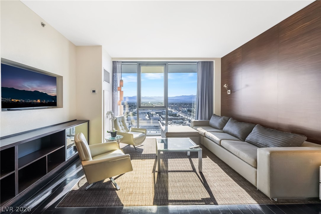 4381 West Flamingo Road, Unit 18305 Las Vegas, NV 89103 - Photo 16 of 19 Floor-to-ceiling windows frame sweeping mountain and city vistas in this inviting living space.