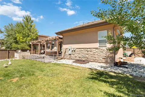 a backyard of a house with table and chairs