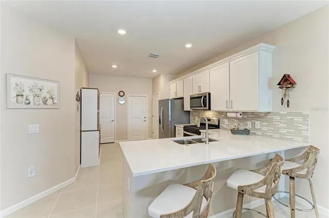 a bedroom with a bed and a flat tv screen on dresser