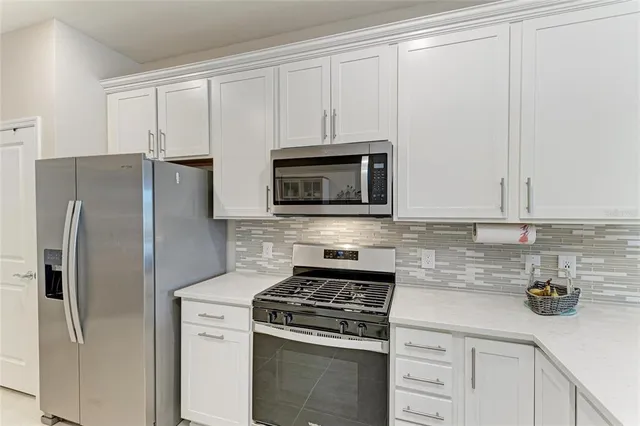 a living room with furniture a flat screen tv and a window
