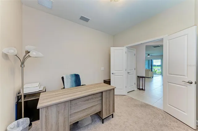 a large white kitchen with kitchen island a large counter space a sink stainless steel appliances and cabinets