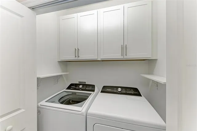 a kitchen with stainless steel appliances kitchen island granite countertop a refrigerator stove and sink