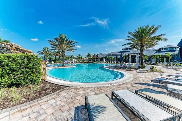 a front view of a house with a yard and a garden