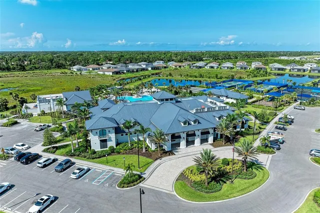 an aerial view of a residential houses with outdoor space and swimming pool