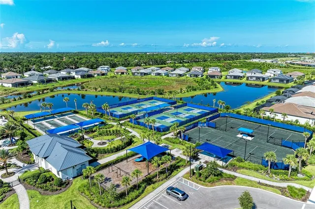 an aerial view of a tennis ground and a city view