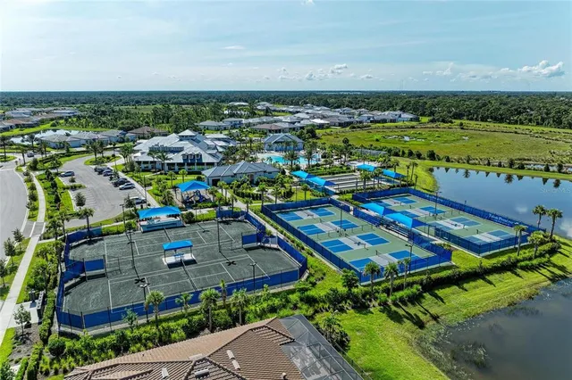 an aerial view of a house with yard swimming pool and outdoor seating