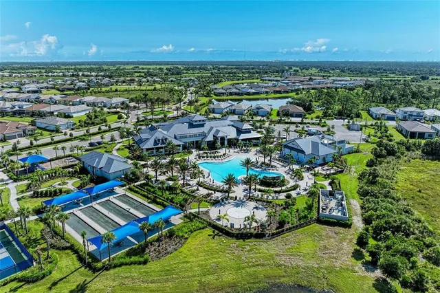 an aerial view of a house with a yard and potted plants