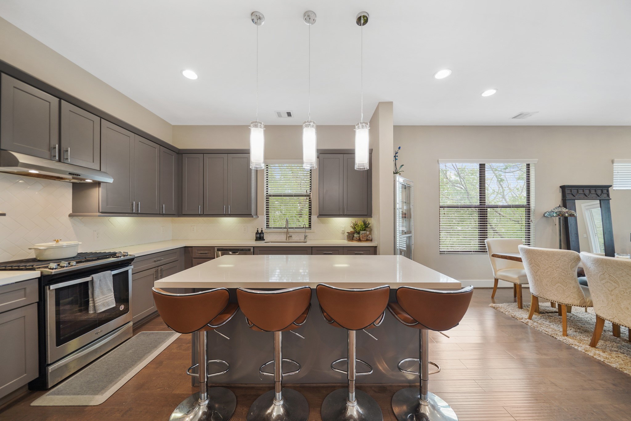 1824 Bonner Street Houston, TX 77007 - Photo 15 of 39 The centrally located island illuminated by pendant lighting offers breakfast bar seating and doubles as a serving bar. Included is a stainless steel beverage fridge tucked away just below the island.