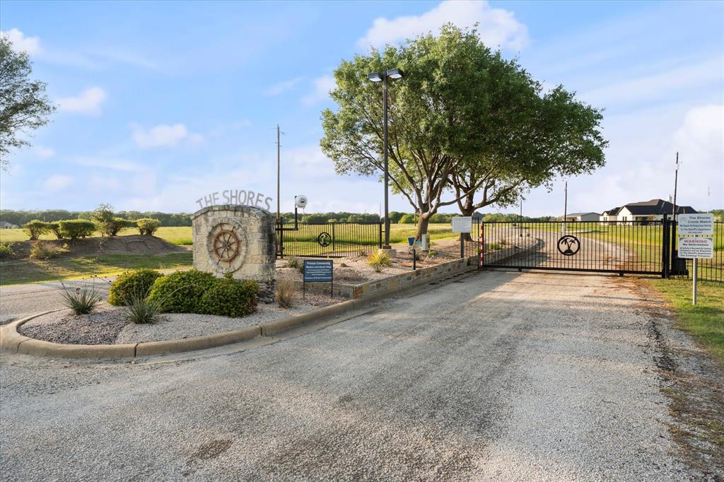 Lot 287 Southeast Pvt Road Corsicana, TX 75109 - Photo 13 of 22 View of road with a gate and street lights