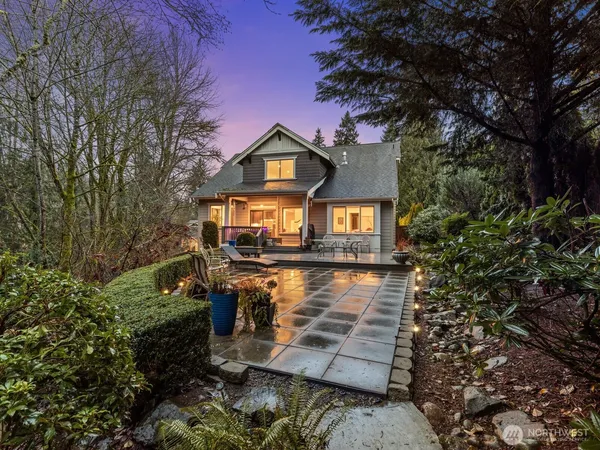 a front view of a house with yard and green space