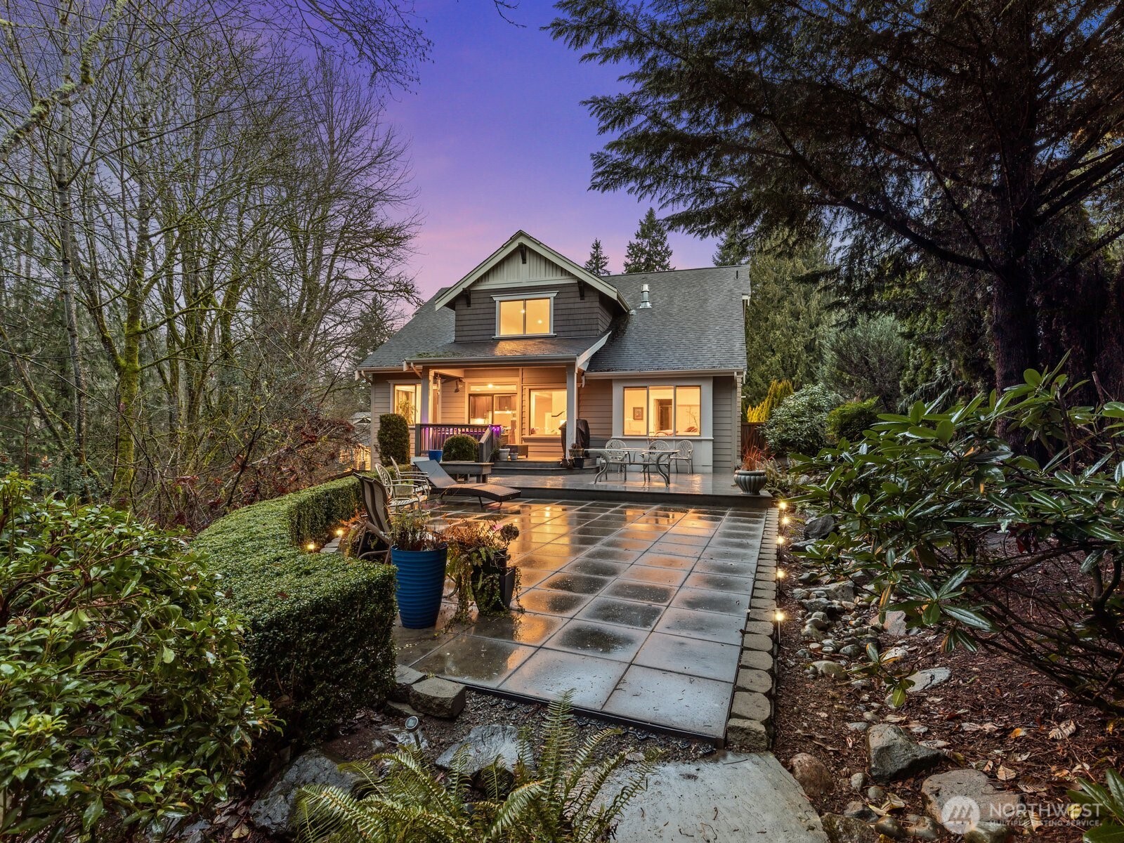 a front view of a house with yard and green space
