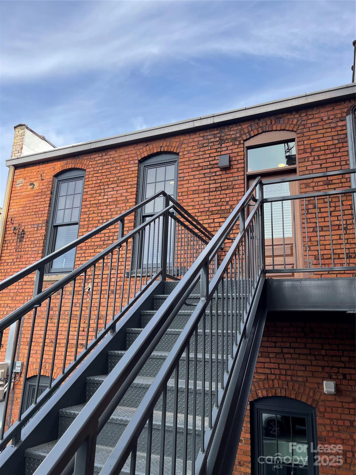 233 West Main Street, Unit B Albemarle, NC 28001 - Photo 11 of 12 a view of staircase with lots of wooden floor and windows