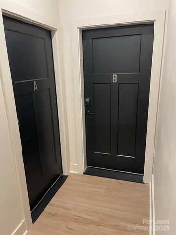 a kitchen with granite countertop a refrigerator and a stove top oven