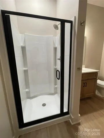 a view of a room with wooden floor