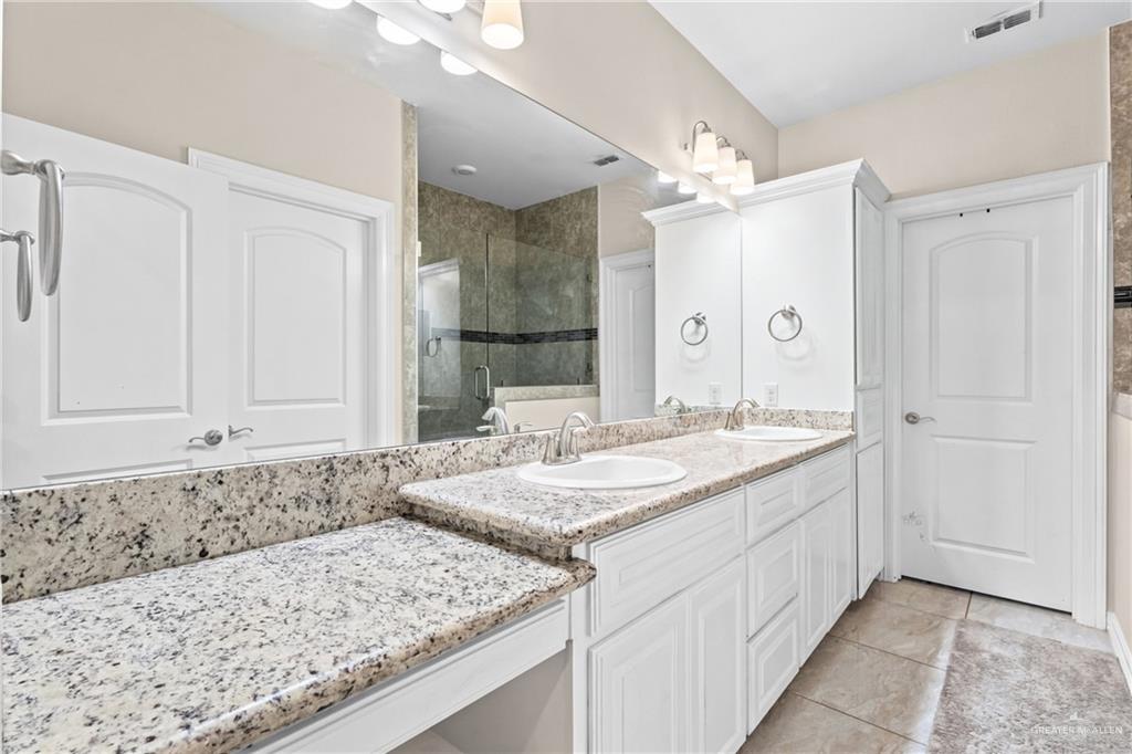 1904 Ridgeway Circle Edinburg, TX 78542 - Photo 19 of 32 Double vanity featuring white cabinetry and light speckled countertops