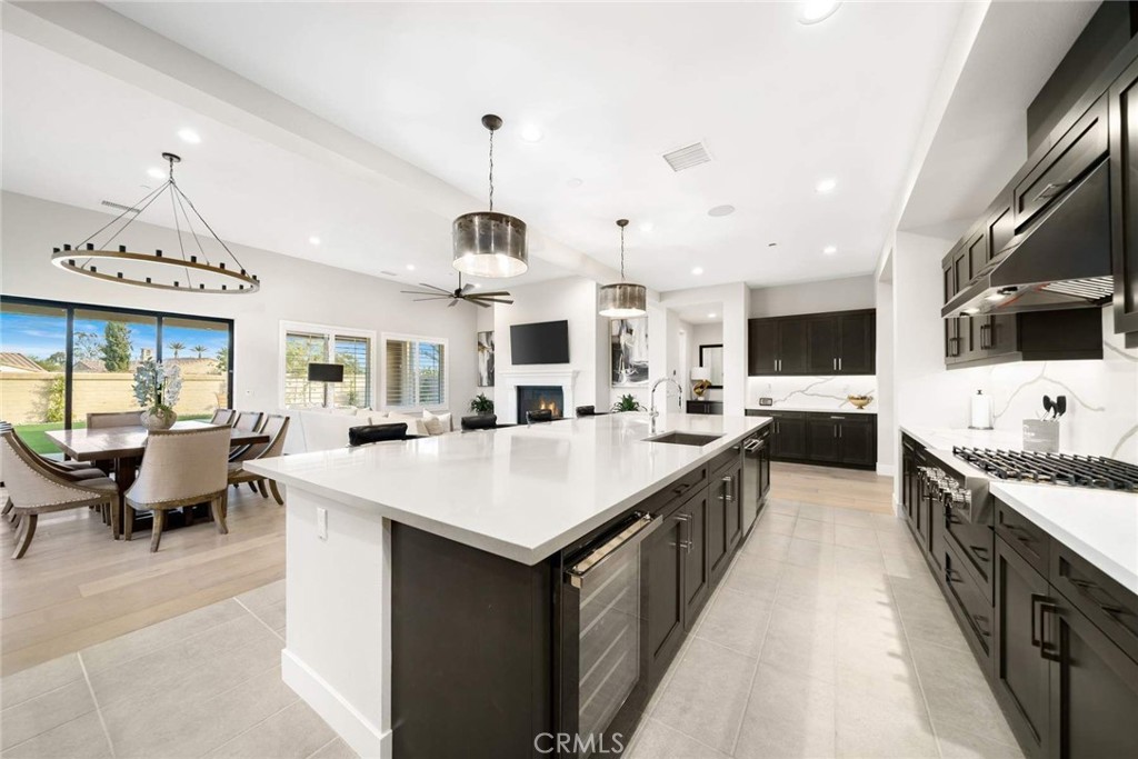 80495 Old Ranch Trail South La Quinta, CA 92253 - Photo 20 of 58 a large kitchen with stainless steel appliances kitchen island a large counter tops and a view of living room