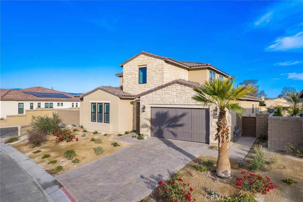 80495 Old Ranch Trail South La Quinta, CA 92253 - Photo 2 of 58 a view of a white house with a yard