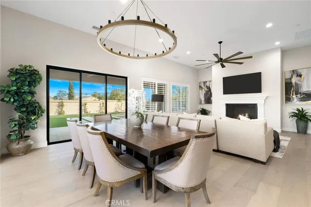 a living room with furniture a large window and a fireplace