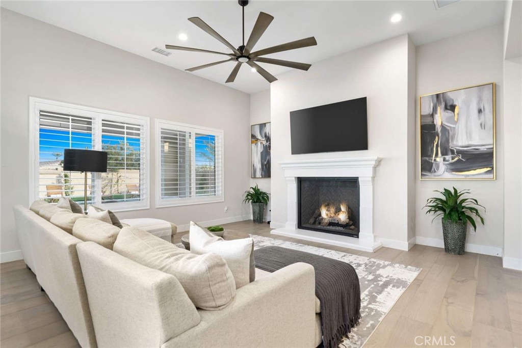 80495 Old Ranch Trail South La Quinta, CA 92253 - Photo 22 of 58 a living room with furniture a fireplace and a flat screen tv