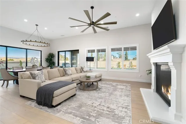 a living room with furniture tv and a large window