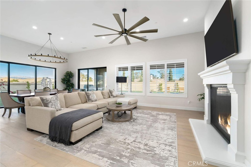 80495 Old Ranch Trail South La Quinta, CA 92253 - Photo 24 of 58 a living room with furniture a large window and a fireplace