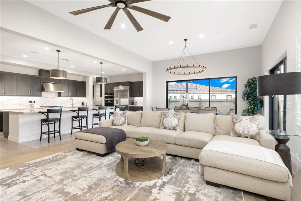 80495 Old Ranch Trail South La Quinta, CA 92253 - Photo 25 of 58 a living room with furniture a chandelier and a dining table