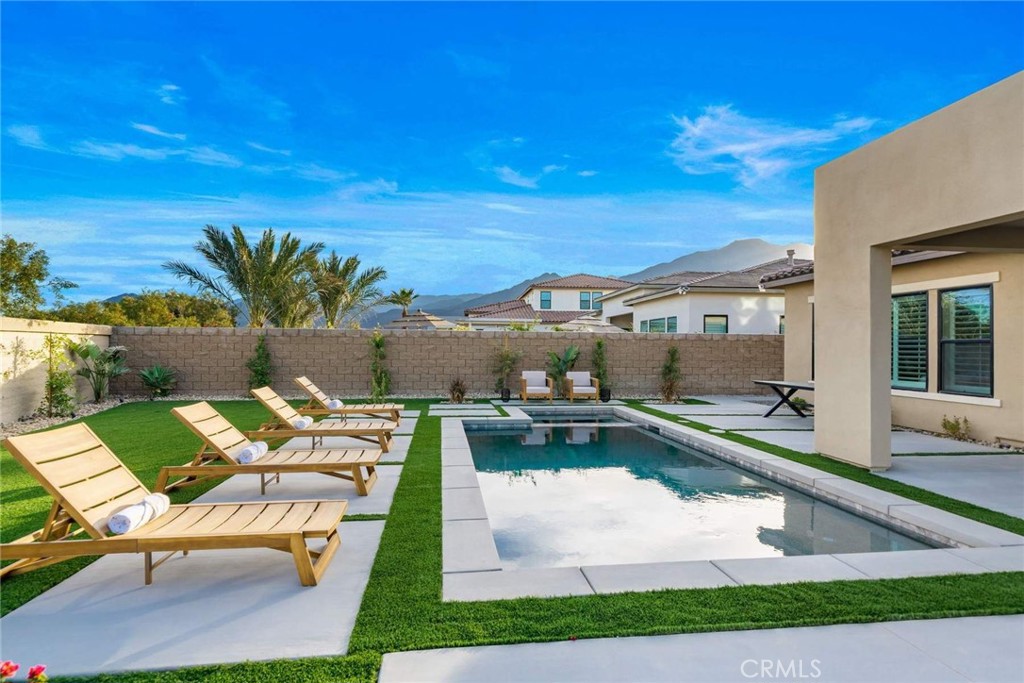 80495 Old Ranch Trail South La Quinta, CA 92253 - Photo 29 of 58 a view of a swimming pool with lounge chair