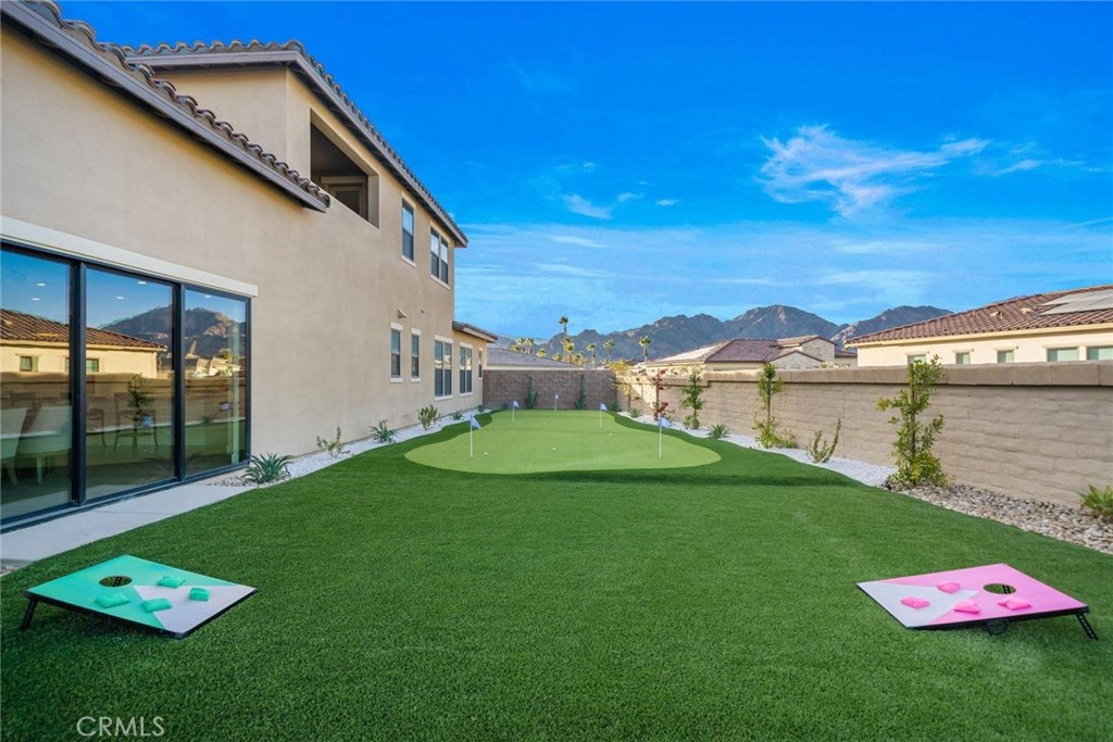80495 Old Ranch Trail South La Quinta, CA 92253 - Photo 32 of 58 a backyard of a house with lots of green space