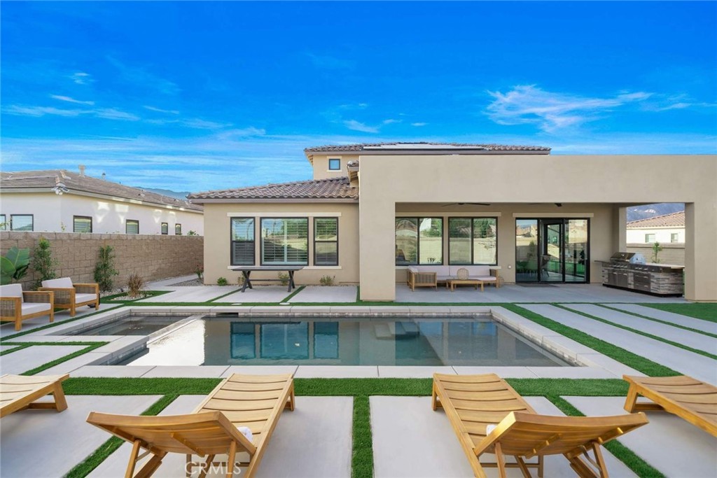 80495 Old Ranch Trail South La Quinta, CA 92253 - Photo 35 of 58 a view of a house with swimming pool and sitting area