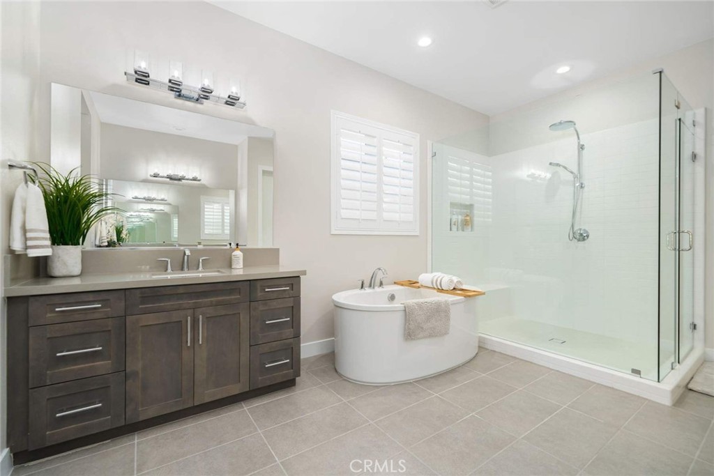 80495 Old Ranch Trail South La Quinta, CA 92253 - Photo 39 of 58 a spacious bathroom with a double vanity sink a large mirror and a bathtub