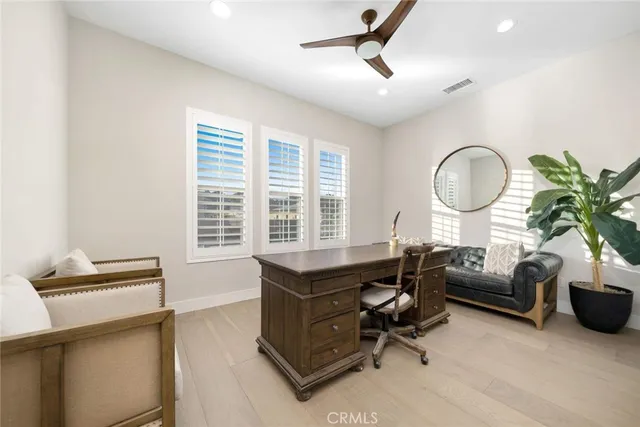 a living room with furniture ceiling fan and a window