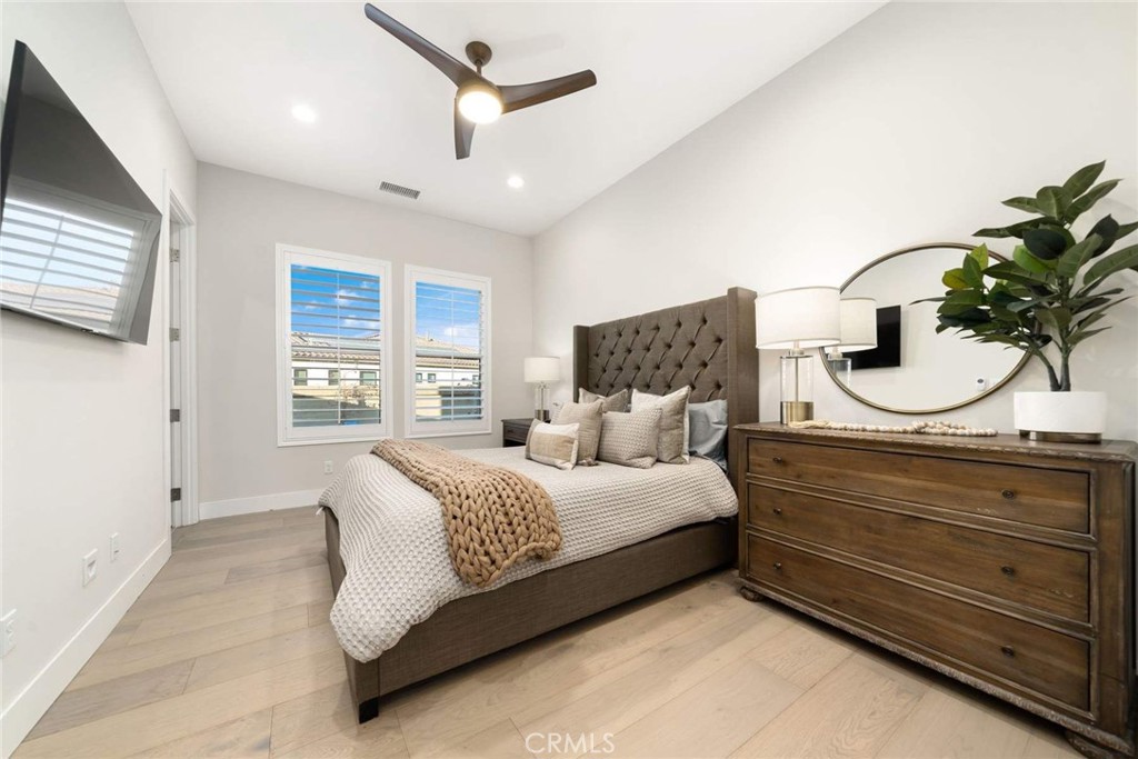 80495 Old Ranch Trail South La Quinta, CA 92253 - Photo 44 of 58 a bedroom with a large bed and a potted plant