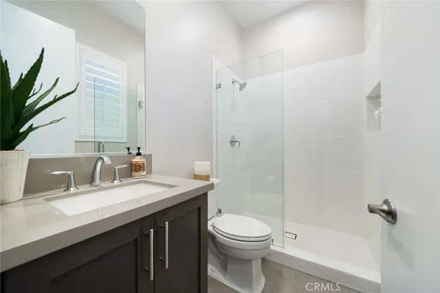 a living room with furniture a flat screen tv and a potted plant