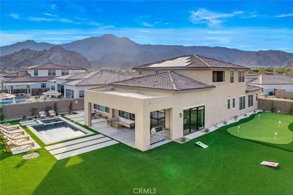 80495 Old Ranch Trail South La Quinta, CA 92253 - Photo 5 of 58 a view of a house with a big yard and large trees
