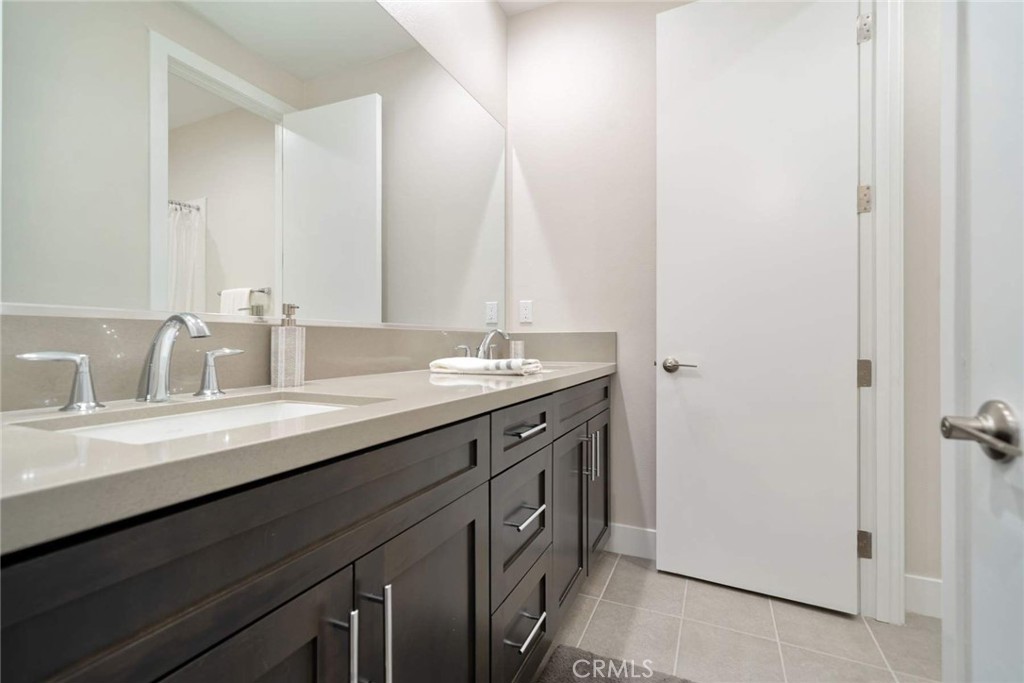 80495 Old Ranch Trail South La Quinta, CA 92253 - Photo 55 of 58 a bathroom with a double vanity sink and a mirror