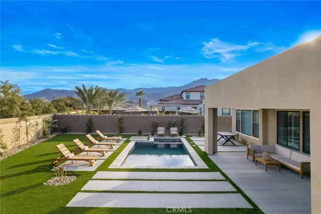 a view of a patio with couches table and a fire pit
